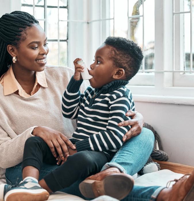 Mom with her son using an inhaler