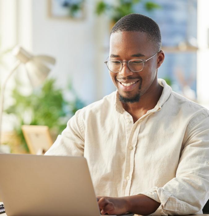 Shot of a young businessman working on his laptop at his desk