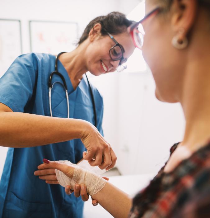  Nurse bandaging a patients arm